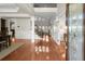 Grand foyer with hardwood floors, staircase, and view of dining room and living spaces at 11240 Avery Cove Ct, Alpharetta, GA 30022