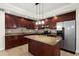 Elegant kitchen features granite countertops, cherry cabinets, stainless steel appliances and a center island at 11240 Avery Cove Ct, Alpharetta, GA 30022