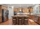 Spacious kitchen with stainless appliances, granite counters, breakfast bar, and light wood cabinets at 11240 Avery Cove Ct, Alpharetta, GA 30022