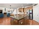 Elegant kitchen with center island, stainless steel appliances, hardwood flooring and connects to the living room at 11240 Avery Cove Ct, Alpharetta, GA 30022
