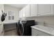 The laundry room features modern black appliances, a sink, and ample counter space at 11240 Avery Cove Ct, Alpharetta, GA 30022