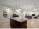 Open concept living room with a stone countertop kitchen island, large windows, and recessed lighting at 11240 Avery Cove Ct, Alpharetta, GA 30022