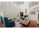 Spacious living room with a fireplace, large windows, and comfortable seating arrangement at 11240 Avery Cove Ct, Alpharetta, GA 30022