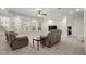 Cozy living room with plush seating, large windows, recessed lighting, and lots of natural light at 11240 Avery Cove Ct, Alpharetta, GA 30022