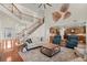 Expansive living room showcasing staircase, hardwood floors and open layout to the kitchen at 11240 Avery Cove Ct, Alpharetta, GA 30022