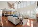 Open-concept living room with hardwood floors, high ceilings, and abundance of natural light at 11240 Avery Cove Ct, Alpharetta, GA 30022