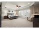 Spacious main bedroom with a ceiling fan, decorative curtains, and lots of natural light at 11240 Avery Cove Ct, Alpharetta, GA 30022