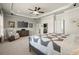 Spacious main bedroom featuring a ceiling fan, sitting area, and decorative ceiling at 11240 Avery Cove Ct, Alpharetta, GA 30022