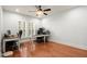 Bright home office with hardwood floors, natural light, and modern desks at 11240 Avery Cove Ct, Alpharetta, GA 30022
