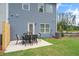 Close-up shot of the backyard patio with furniture on a well-maintained lawn at 123 Ravencliff Dr # 80, Austell, GA 30168
