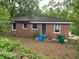 Exterior view of a brick home with a backyard, featuring several windows, and a back door at 2545 Saint Patrick Se St, Atlanta, GA 30317