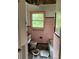 This bathroom is in need of extensive renovation; it features a pink tile surround and toilet at 2545 Saint Patrick Se St, Atlanta, GA 30317