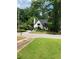 Well-maintained two-story home with dark roof, a cozy front porch, and tree-lined streets at 2545 Saint Patrick Se St, Atlanta, GA 30317
