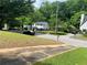 A tranquil street view of homes and trees showcases a peaceful neighborhood setting at 2545 Saint Patrick Se St, Atlanta, GA 30317