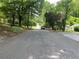 A view of the neighborhood street with greenery trees and a house at the end at 2545 Saint Patrick Se St, Atlanta, GA 30317