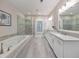 Modern bathroom featuring a soaking tub, glass shower, and double vanity with quartz countertops at 396 Summerhour St, Marietta, GA 30060