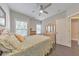 A bedroom with hardwood floors, a ceiling fan, and natural light from two windows at 396 Summerhour St, Marietta, GA 30060