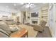 Living area with a fireplace, built-in shelving, and an open layout to the kitchen and dining space at 396 Summerhour St, Marietta, GA 30060