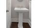 Well-lit powder room features a modern pedestal sink and neutral paint, providing a functional space for guests at 396 Summerhour St, Marietta, GA 30060