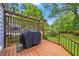 A wooden back deck with a grill, pergola, and lattice wall offers an inviting outdoor space at 511 Robinson Se Ave, Atlanta, GA 30315