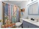 Bathroom with a blue vanity, stylish sink, decorative mirror and unique shower curtain at 511 Robinson Se Ave, Atlanta, GA 30315