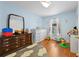 Cozy bedroom features a light blue wall, dresser, and natural light at 511 Robinson Se Ave, Atlanta, GA 30315