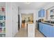 Open kitchen with blue cabinets, stainless appliances, island, and pantry storage at 511 Robinson Se Ave, Atlanta, GA 30315