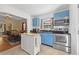Cozy kitchen features blue cabinets, stainless steel appliances, and a view into the dining room at 511 Robinson Se Ave, Atlanta, GA 30315