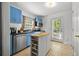 Bright kitchen with stainless steel appliances, blue cabinets, and a convenient kitchen island at 511 Robinson Se Ave, Atlanta, GA 30315