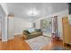 Bright living room featuring hardwood floors, a large patterned rug, and a comfortable couch at 511 Robinson Se Ave, Atlanta, GA 30315