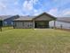 Expansive backyard with a covered patio, offering a private outdoor space for relaxation and entertainment at 8315 Loch Lomand Ln, Winston, GA 30187