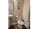 Cozy half-bath featuring a pedestal sink, elongated toilet, and decorative wall accents at 8315 Loch Lomand Ln, Winston, GA 30187