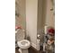 Cozy half-bath featuring an elongated toilet and convenient storage solutions at 8315 Loch Lomand Ln, Winston, GA 30187