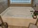 Cozy white soaking tub with brushed nickel hardware and tile surround at 8315 Loch Lomand Ln, Winston, GA 30187