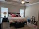 Well-lit bedroom with neutral carpet, queen bed, and a ceiling fan at 8315 Loch Lomand Ln, Winston, GA 30187