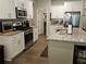 Spacious kitchen with white cabinets, granite countertops, and modern stainless steel appliances at 8315 Loch Lomand Ln, Winston, GA 30187