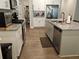 Modern kitchen with white cabinets, granite countertops, stainless appliances, and eat-in island at 8315 Loch Lomand Ln, Winston, GA 30187
