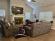 Inviting living room with vaulted ceilings, stone fireplace, plush seating, and natural light at 8315 Loch Lomand Ln, Winston, GA 30187