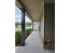 Covered porch with stone accents and dark columns creates a welcoming entrance at 8315 Loch Lomand Ln, Winston, GA 30187