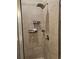 Tiled shower with showerhead and convenient built-in shelving at 8315 Loch Lomand Ln, Winston, GA 30187