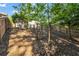 View of a backyard featuring tree canopy, wooden fence, and shade-covered ground at 3504 Benthollow Ln, Duluth, GA 30096