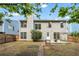 View of a backyard featuring trees, wooden fencing, covered patio and a glimpse of home's back exterior at 3504 Benthollow Ln, Duluth, GA 30096