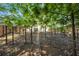 Backyard view featuring stone pathway beneath greenery-filled tree canopy and fenced perimeter at 3504 Benthollow Ln, Duluth, GA 30096
