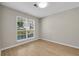 Bright bedroom features a large window and wood-look flooring at 3504 Benthollow Ln, Duluth, GA 30096