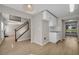Inviting entryway featuring hardwood floors, staircase, and adjacent kitchen area with white cabinetry at 3504 Benthollow Ln, Duluth, GA 30096