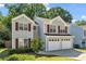 Attractive two-story home featuring a two-car garage and mature trees, providing a private setting at 3504 Benthollow Ln, Duluth, GA 30096