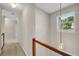 Upstairs hallway with neutral carpet, lighting fixture, and view of the staircase at 3504 Benthollow Ln, Duluth, GA 30096