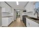 Bright kitchen with white cabinets, stainless steel appliances, and wood floors, offering a clean and modern look at 3504 Benthollow Ln, Duluth, GA 30096