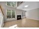 Bright and airy living room featuring a fireplace, large windows, and beautiful wood flooring, ideal for relaxation at 3504 Benthollow Ln, Duluth, GA 30096