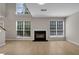 Inviting living room with a cozy fireplace, large windows, and hardwood flooring, creating a warm atmosphere at 3504 Benthollow Ln, Duluth, GA 30096